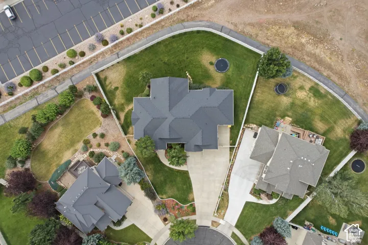 Expansive property featuring a large grass lawn, mature trees, and landscaping