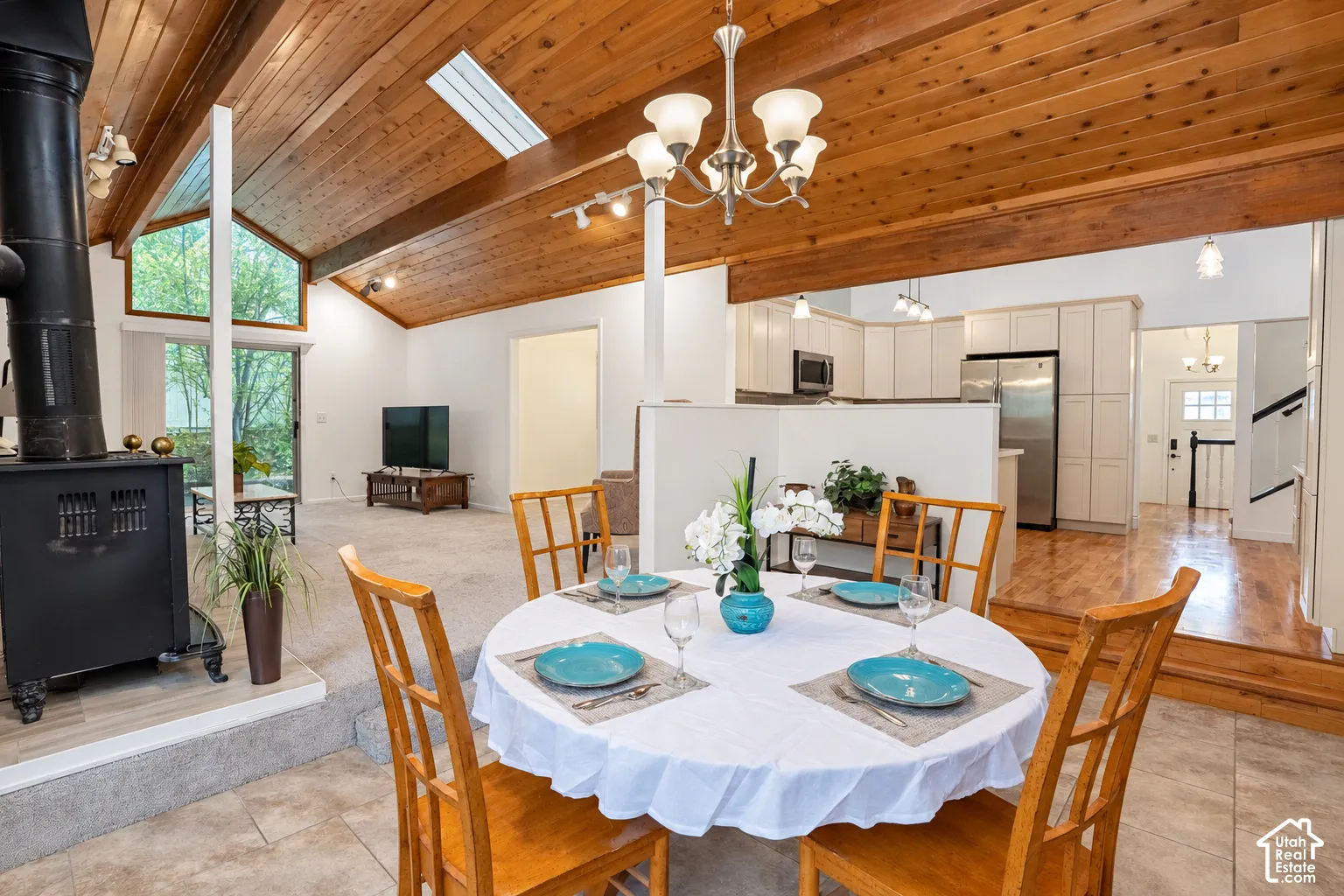 Vaulted wood-paneled ceiling with skylight, recessed lighting, and chandelier, New paint and carpet