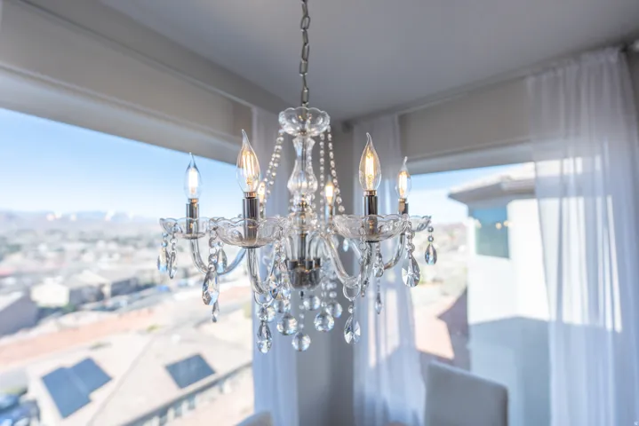 Crystal chandelier with sconce-style bulbs and a chain suspension