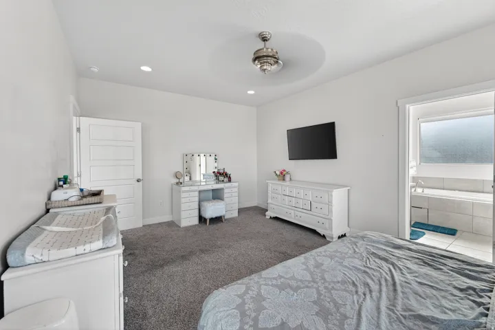 Recessed lighting, ceiling fan, and carpeted flooring