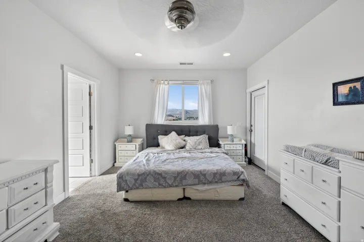 Carpeted room featuring a ceiling fan and recessed lighting