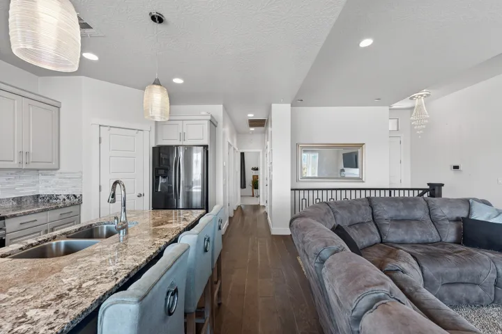 Kitchen island with an undermount double sink, a high-arc faucet, and granite countertops