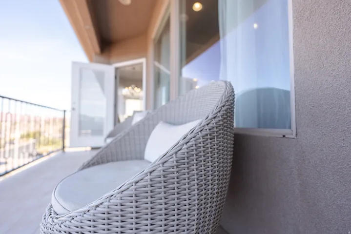 Exterior balcony with a metal railing and a stucco exterior finish
