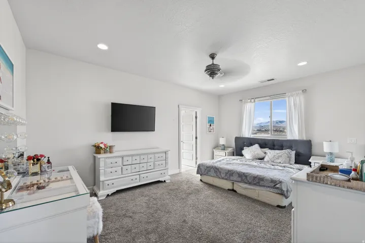 Recessed lighting, ceiling fan, and carpeted flooring