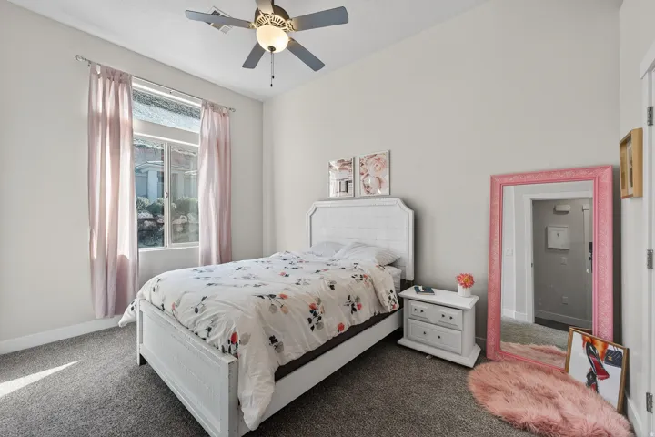 Room featuring a ceiling fan with integrated lighting, a double-paned window, and neutral wall paint