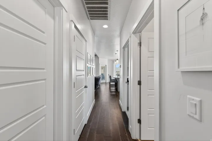Dark wood-finish flooring extending through the hallway