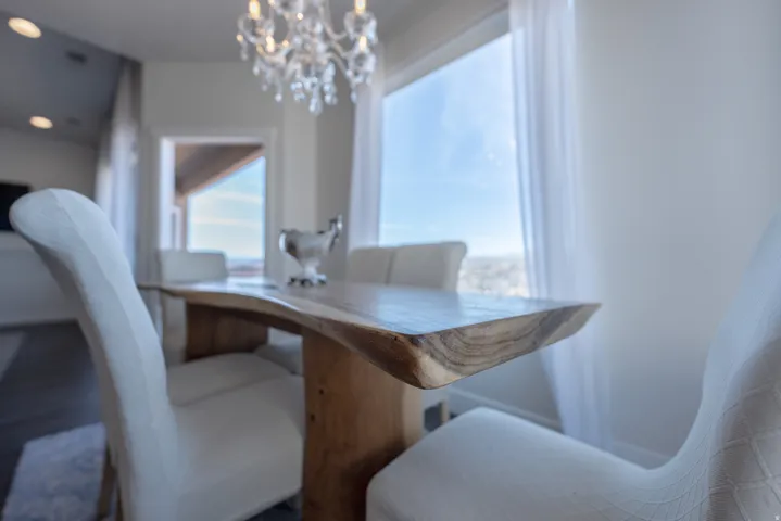 Recessed lighting, wood-finish flooring, and a crystal chandelier