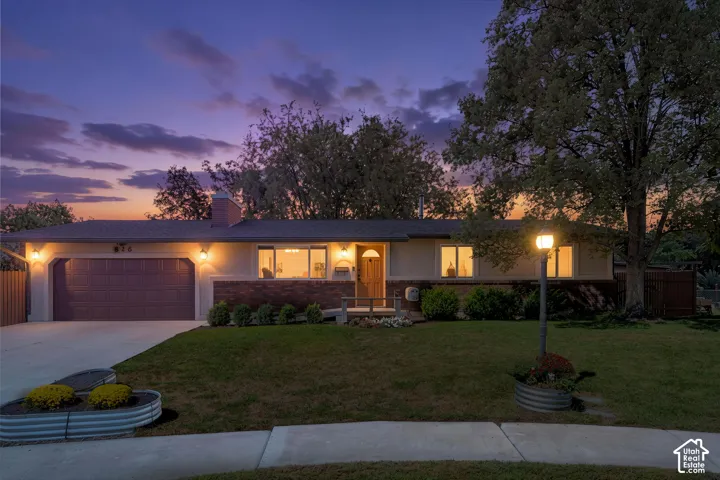 Rambler home featuring a two-car garage