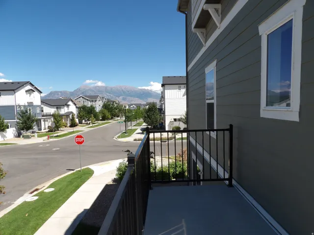Exterior balcony with black metal railings and direct mountain scenery