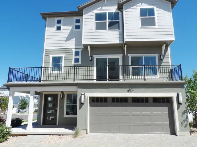 Multi-level facade featuring varied siding and stucco finishes