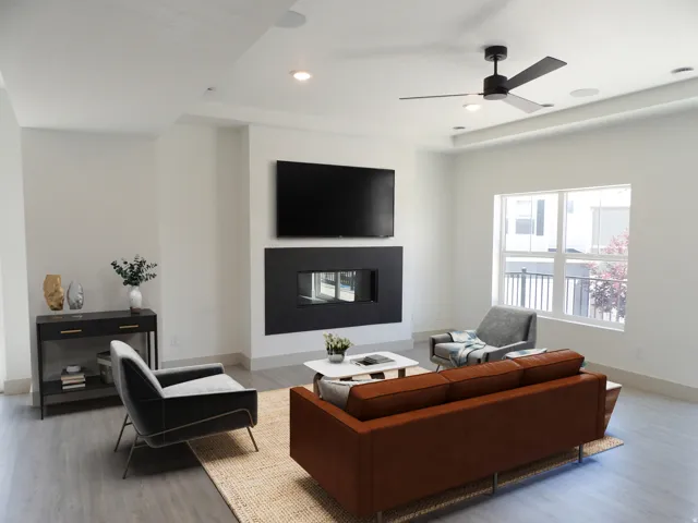 Recessed lighting, ceiling fan, wood-finish flooring, built-in fireplace, and tray ceiling