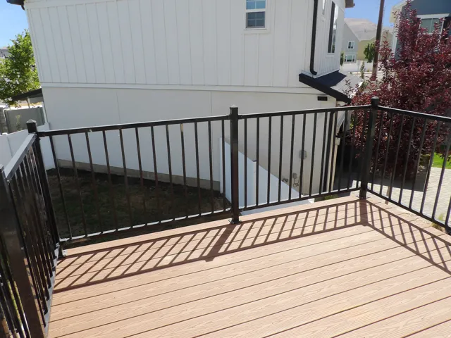 Exterior deck featuring composite decking and black metal railings