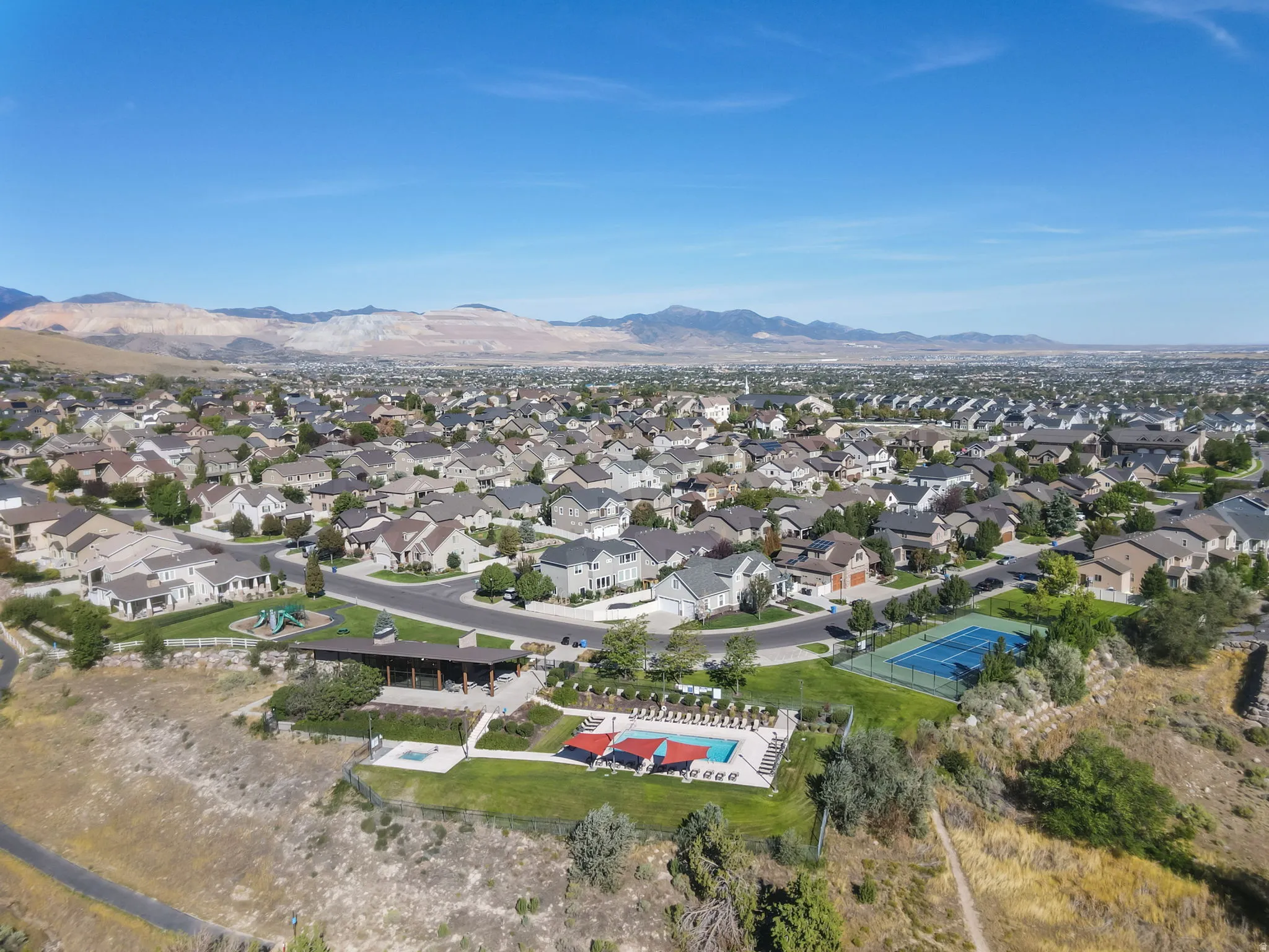 Community amenities featuring a tennis court, swimming pool, and covered pavilion