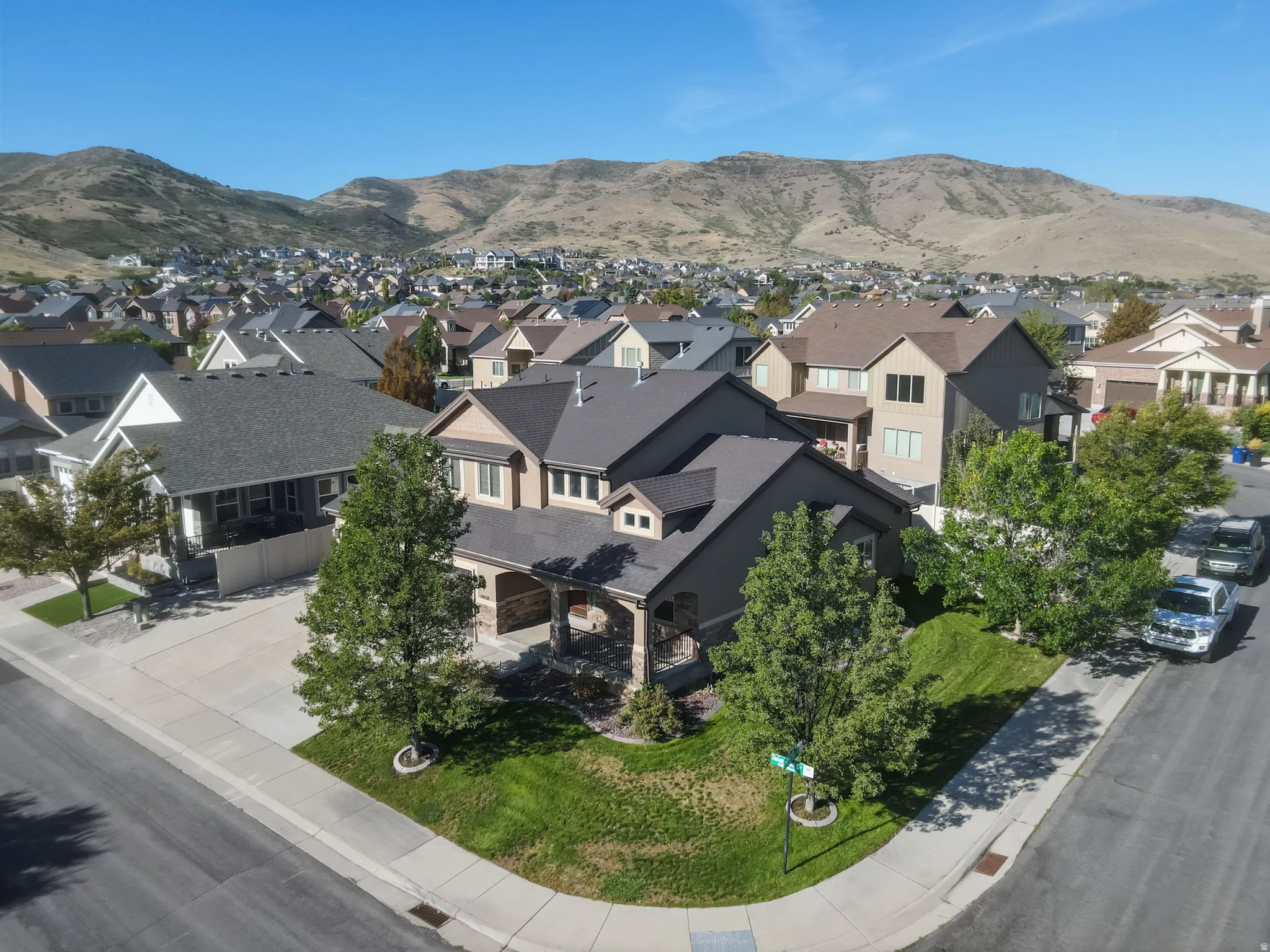 Multi-story residence featuring a covered front porch and a stone and siding exterior