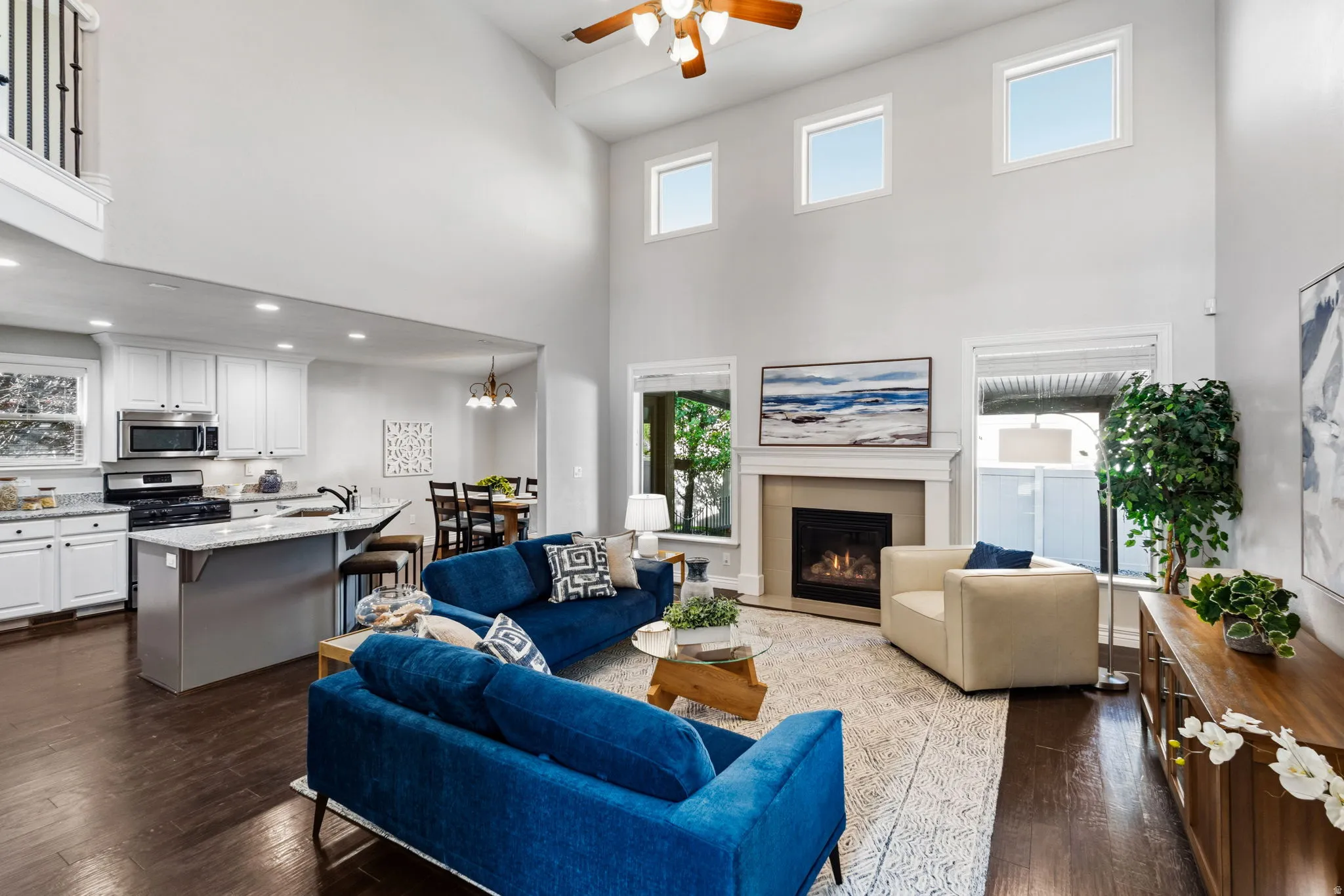 Two-story living area with a fireplace and large windows