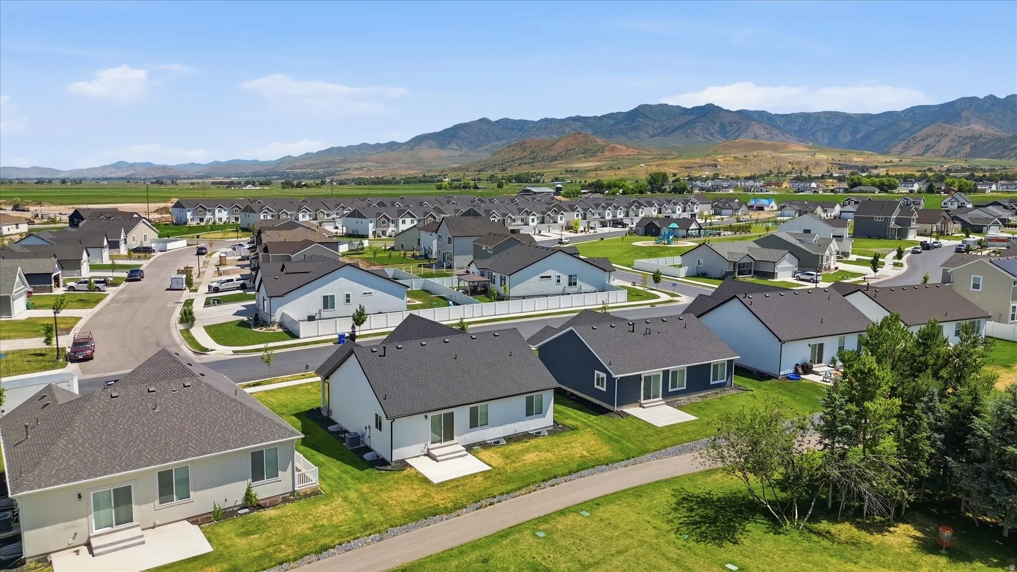 Expansive residential area featuring single-story homes, dark shingle roofs, and light-colored siding