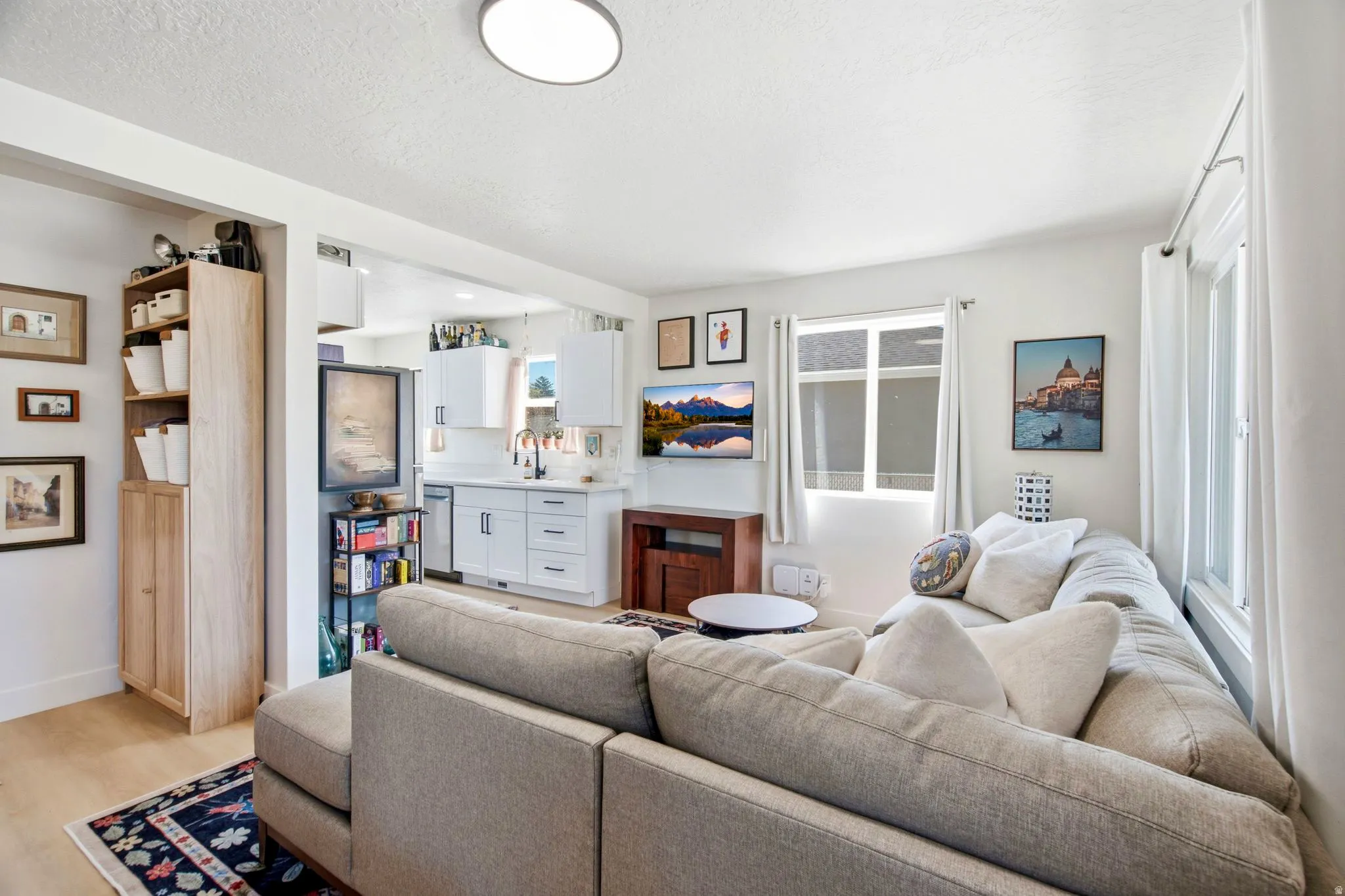 Open-concept living space with wood-finish flooring