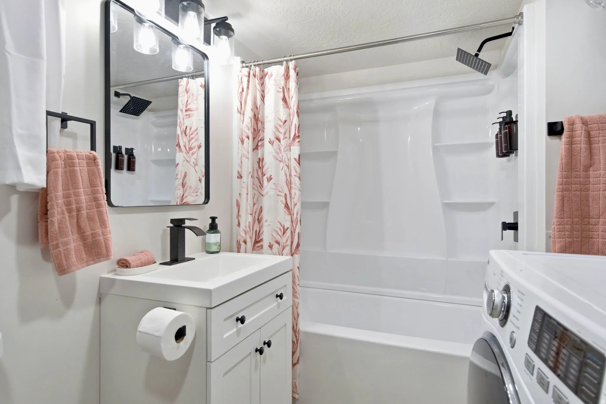 White vanity with undermount sink and matte black faucet