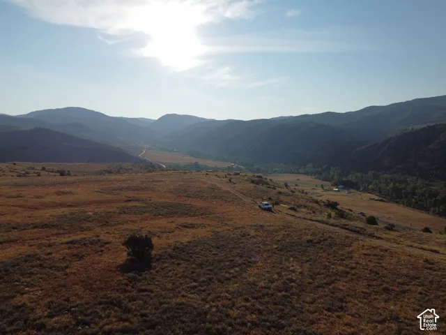 Expansive undeveloped land featuring rolling hills and distant mountains