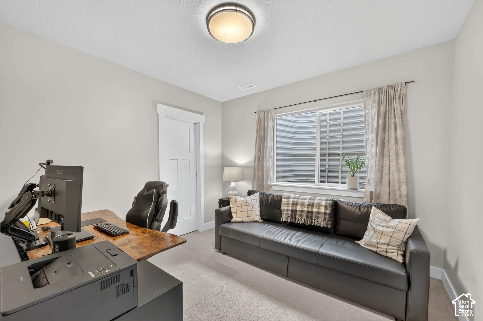 Recessed window with white trim, light-toned carpeting, white interior door with paneling, and a flush-mount ceiling light fixture