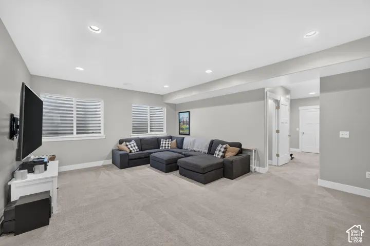 Recessed lighting, light gray wall paint, white trim, and carpeted flooring