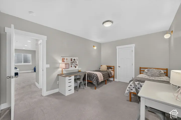 Light gray wall finishes, gray carpeting, white trim work, white interior doors, and ceiling-mounted lighting fixtures