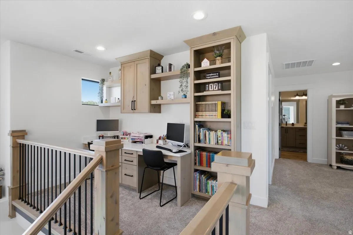 Built-in wood-finish cabinetry, integrated shelving, and a dedicated workspace