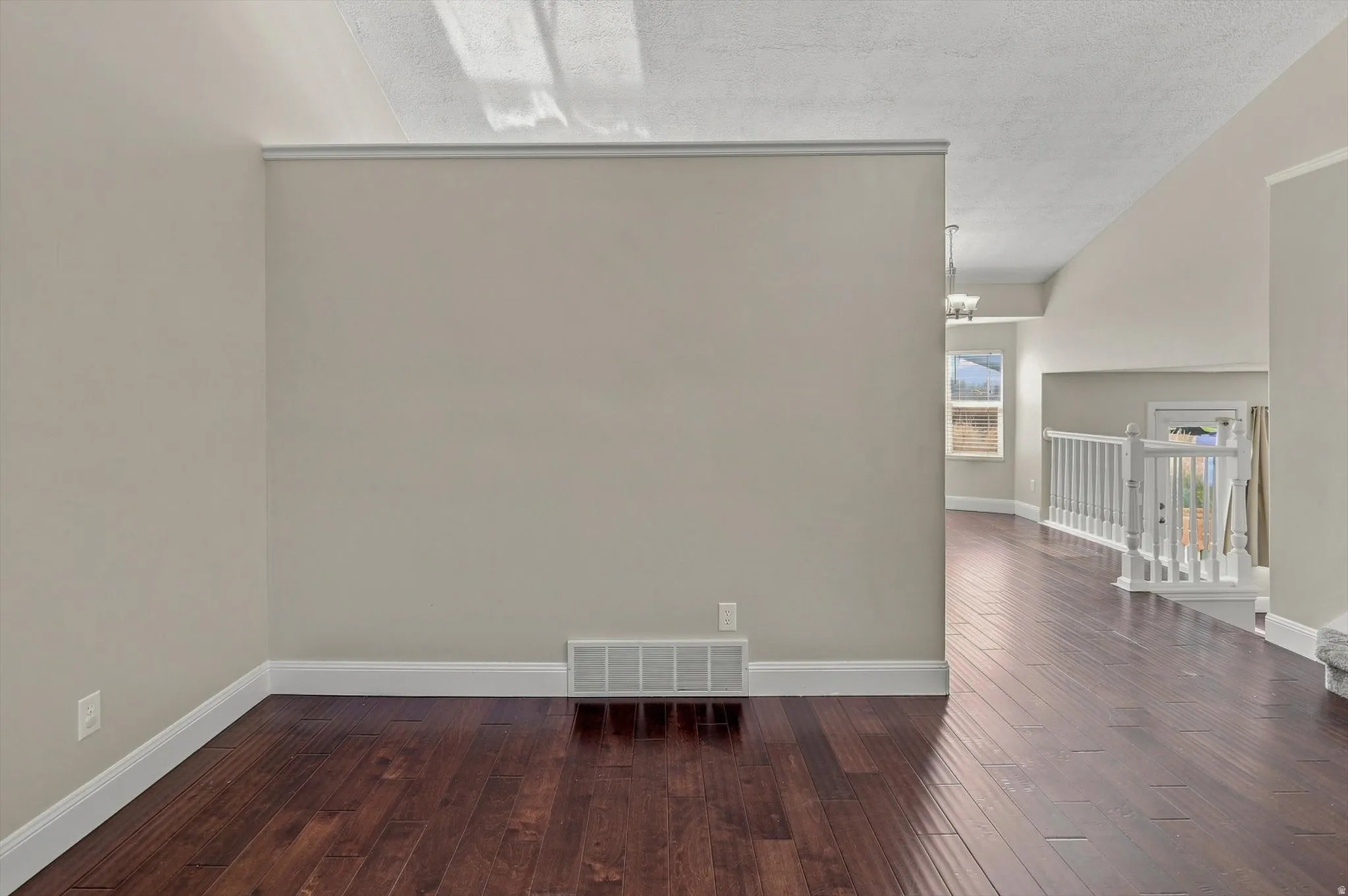 Wood-finish flooring, white trim, and light wall paint