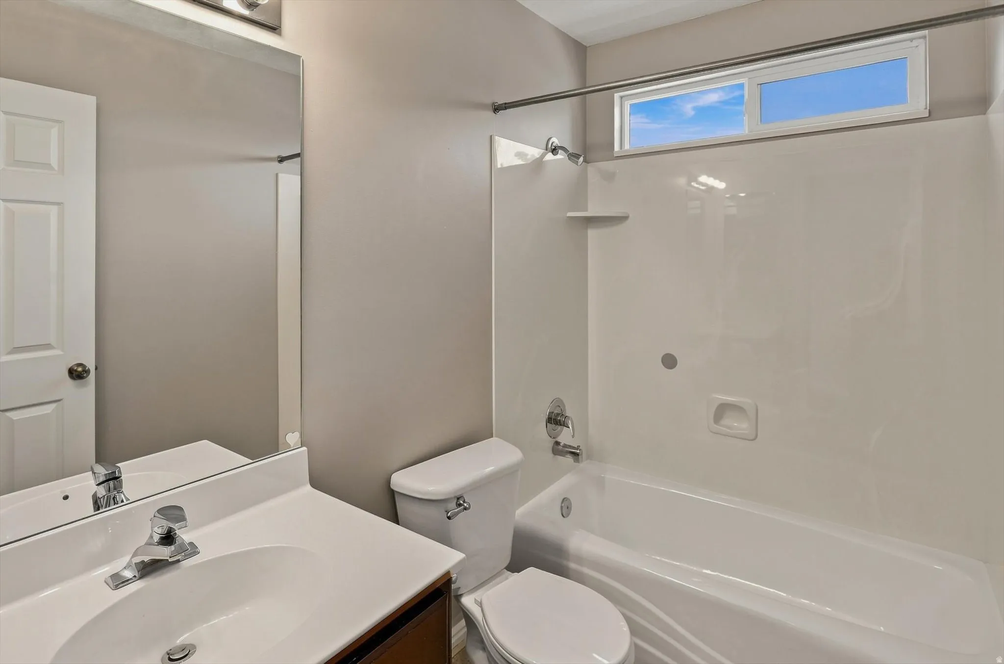 White vanity with integrated sink and chrome faucet
