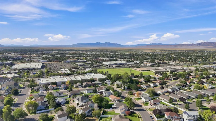 Expansive neighborhood setting with residential properties and distant mountain backdrop