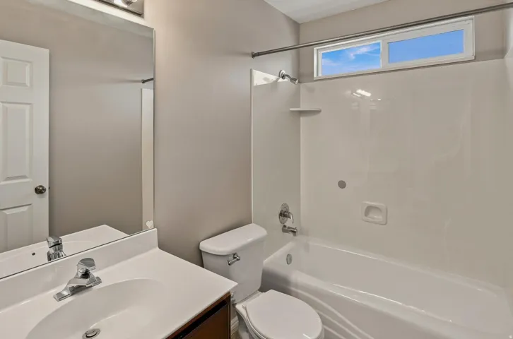 White vanity with integrated sink and chrome faucet