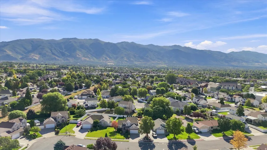Mountain backdrop, residential area, mature trees, paved streets, single-family homes