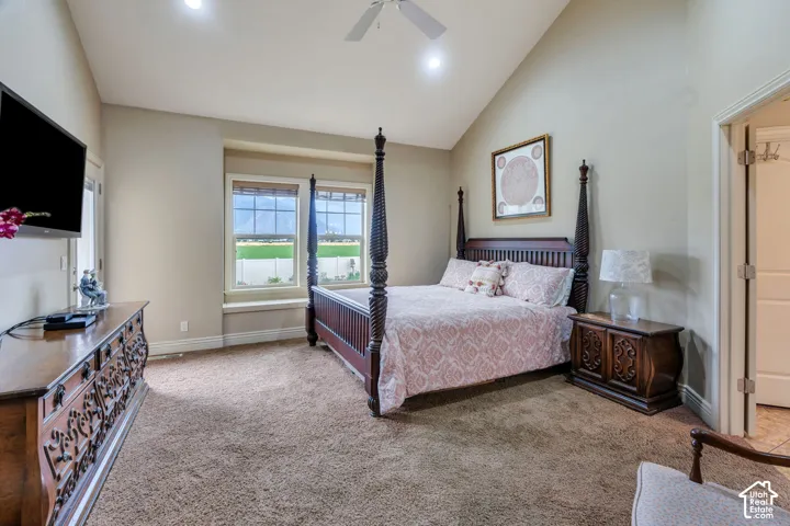 Vaulted ceilings with recessed lighting, plush carpeting, multiple windows with blinds, and a ceiling fan