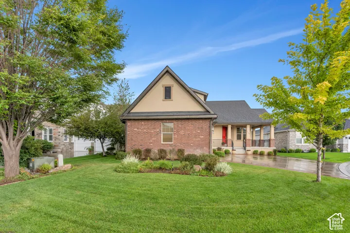 Brick and stucco exterior with a dark shingle roof