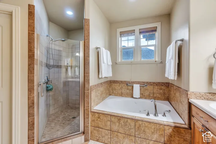 Walk-in shower with clear glass enclosure and tile surround