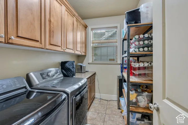 Maple-finish cabinetry, tiled flooring, built-in shelving, and a window with blinds