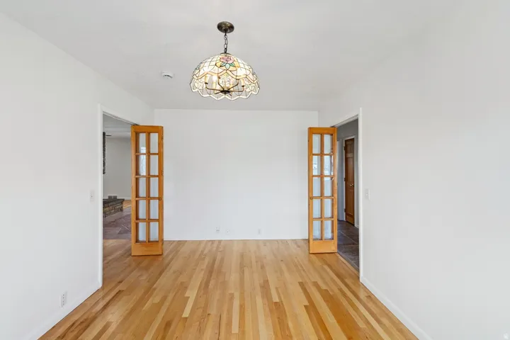 Hardwood flooring throughout, with a decorative ceiling-mounted light fixture