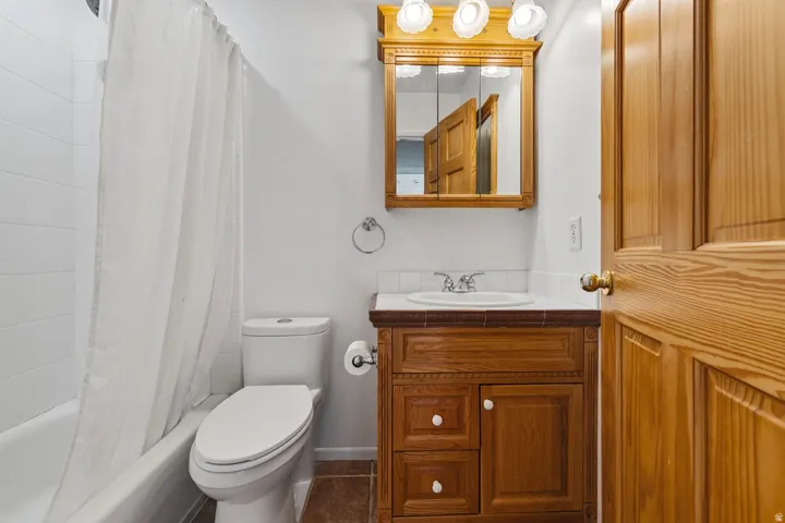 Wood-finish vanity with a surface-mounted sink and wall-mounted medicine cabinet