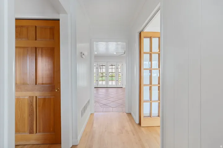 Wood-finish flooring throughout the hallway