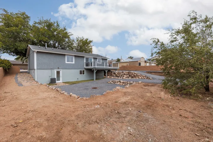 Back of house with walk out basement and deck.