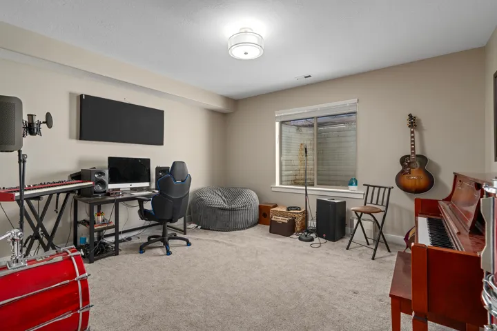 Recessed lighting, light-colored walls, and carpeted flooring