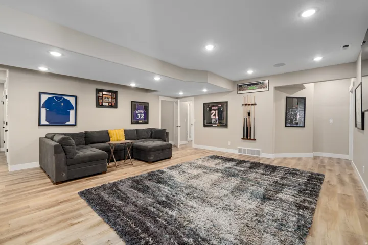 Recessed lighting, light wood-finish flooring, light neutral-toned walls, white trim, and a white ceiling