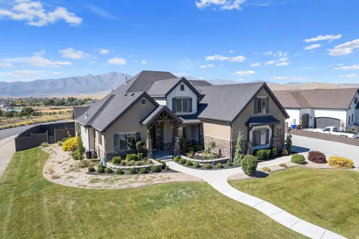 Stucco and stone exterior with dark trim accents
