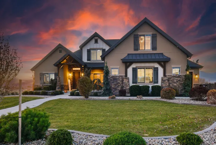Stucco and stone exterior with dark trim accents