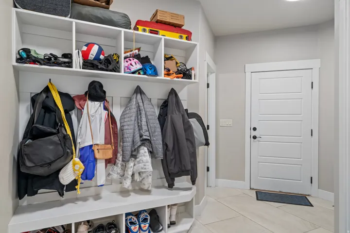 Built-in storage cabinetry with integrated coat hooks and shelving