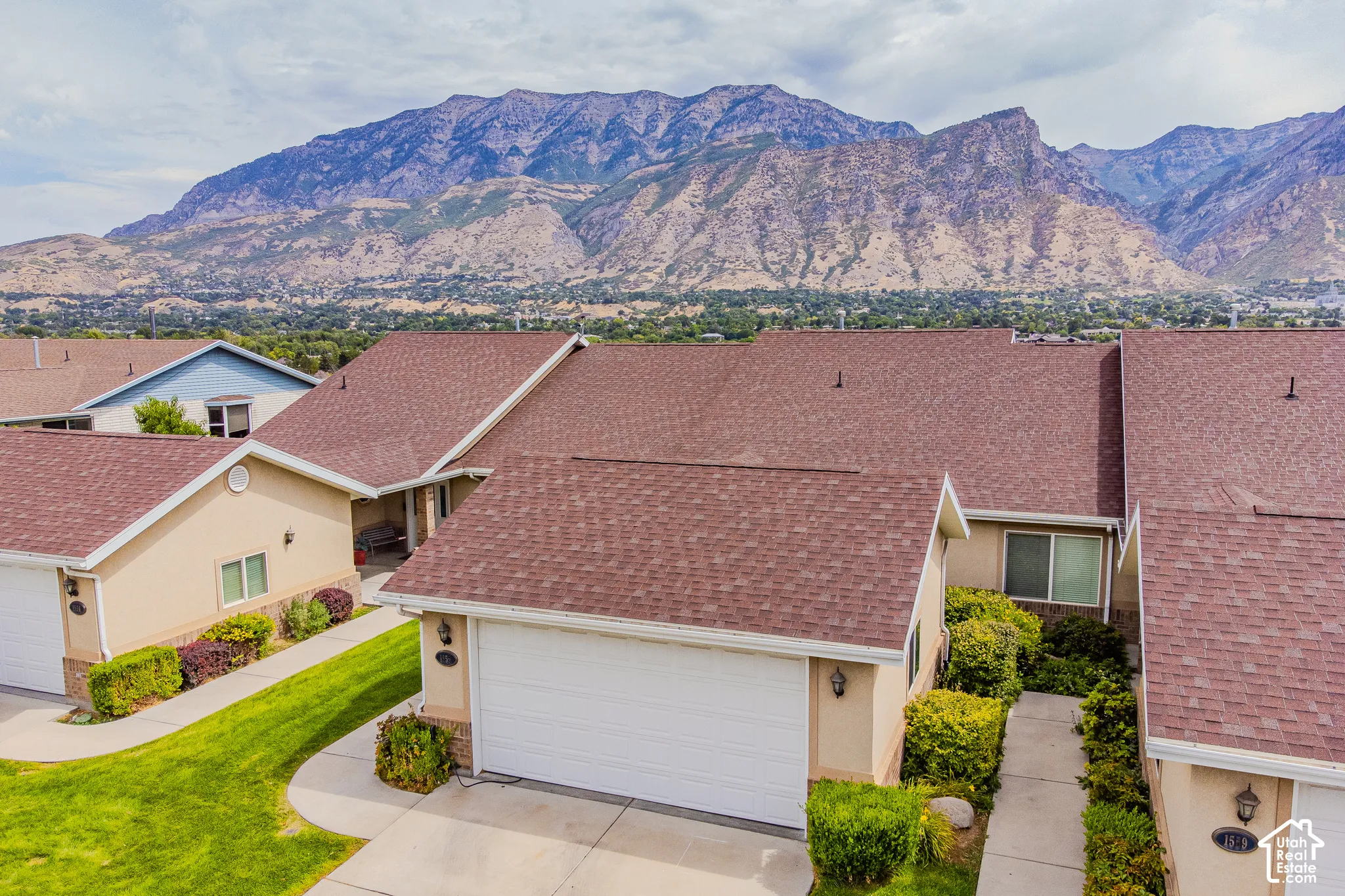 Single-story property with stucco exterior, attached garage, and mature landscaping
