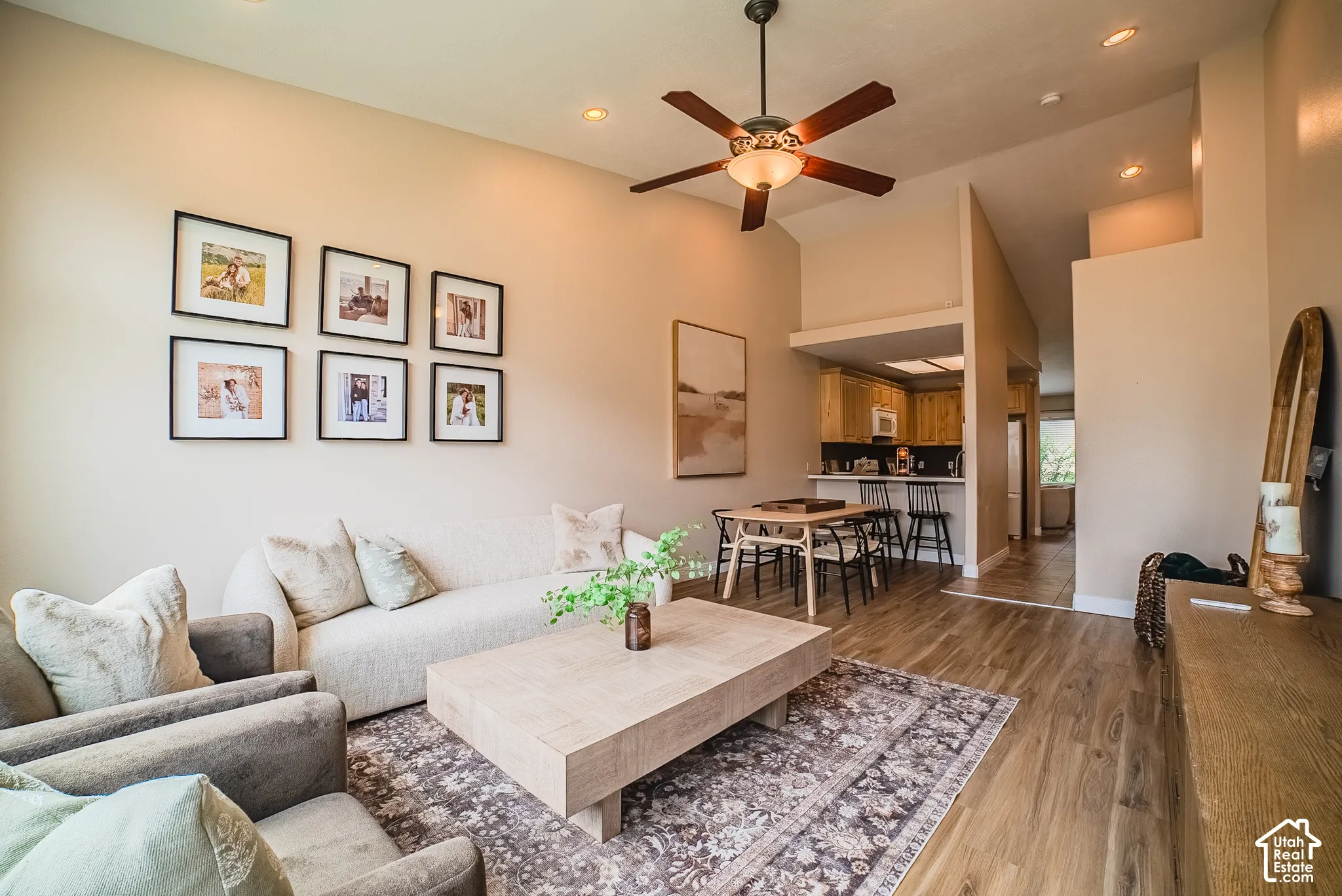 Vaulted ceilings with recessed lighting, wood-finish flooring, and a ceiling fan