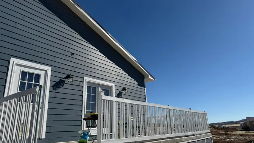 Exterior featuring horizontal siding, white trim, and a white-railed deck