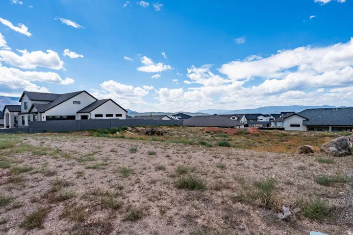Expansive land parcel with surrounding residential properties, offering mountain scenery