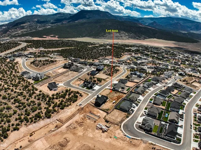 Aerial perspective of a developing residential area with paved streets and established homes